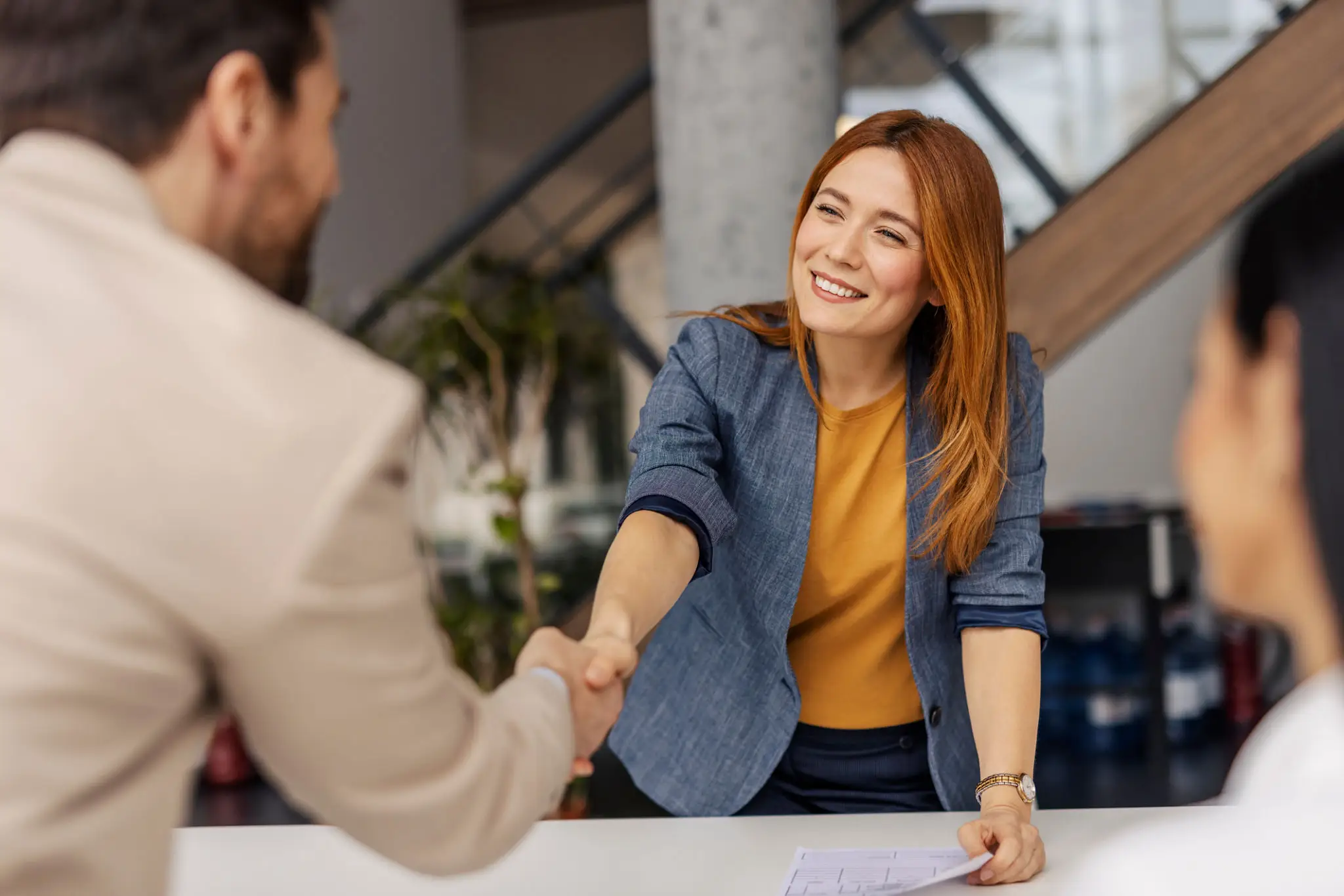 Smiling businesswoman shaking hands during meeting