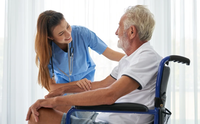 Healthcare worker with elderly man in wheelchair