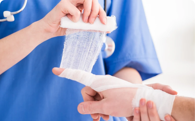 Nurse wrapping a hand with gauze