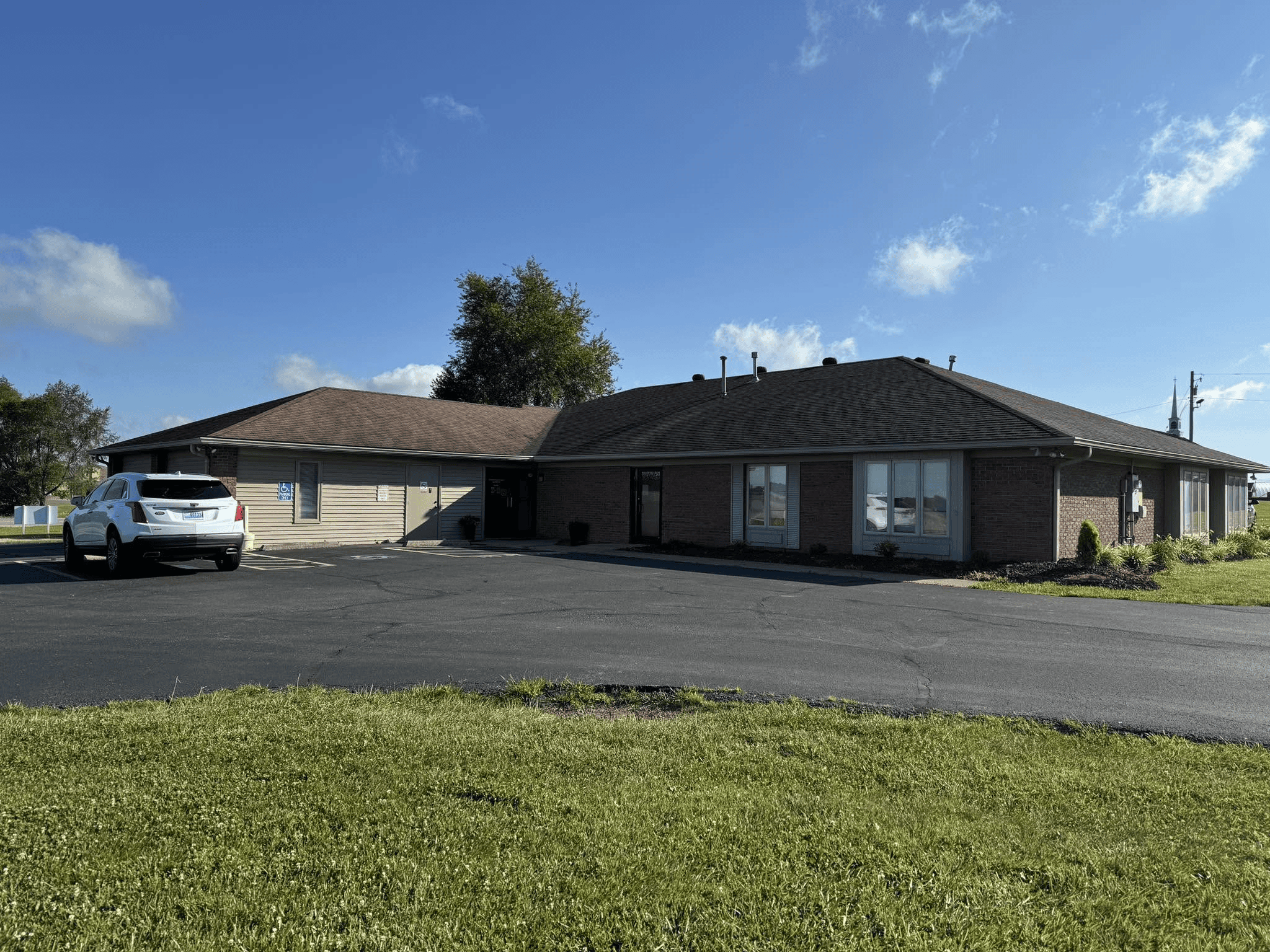 single-story brick building with parking lot